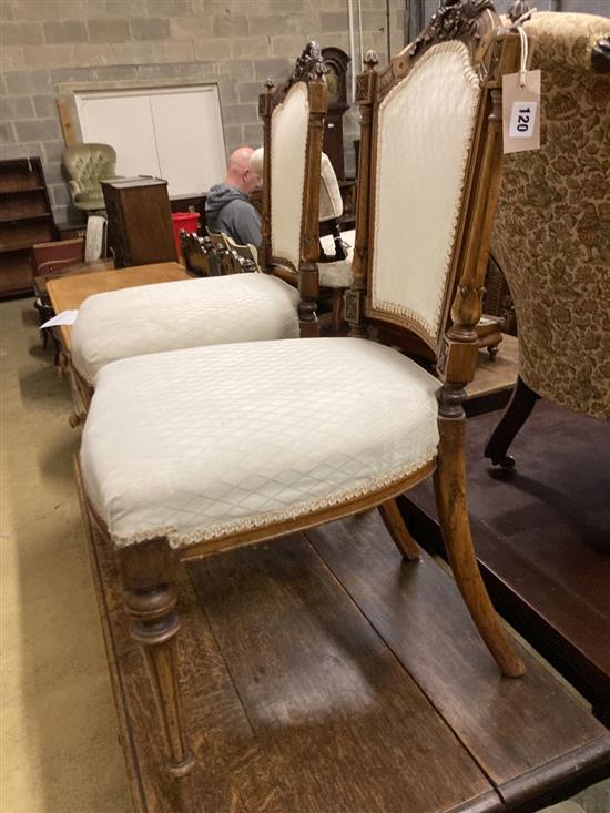 A pair of Victorian carved walnut salon chairs